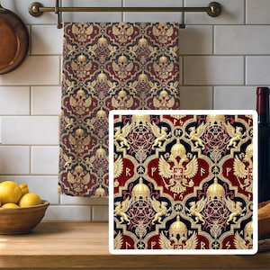 May include: A decorative kitchen towel with a repeating pattern of gold eagles, domes, and geometric shapes on a burgundy and navy blue background. The towel is hanging on a brass rod in a kitchen setting.
