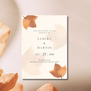 Może przedstawiać: Zaproszenie ślubne z beżowym tłem i brązowymi liśćmi. Tekst brzmi "You are invited to the wedding of Samira & Martin Oct 23 2024 The Plaza Hotel 768 Fifth Avenue, New York, NY 10019"