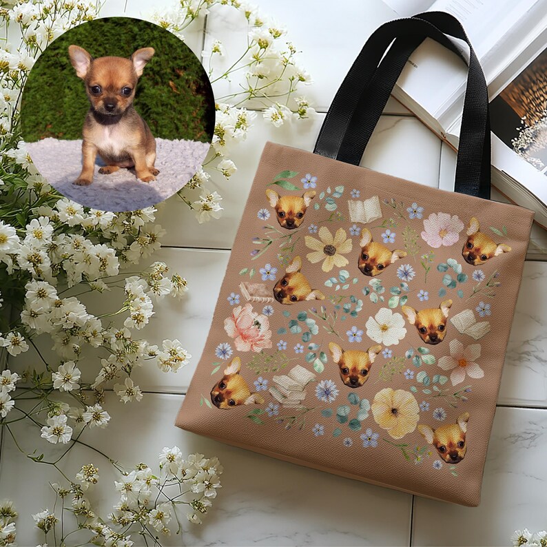 May include: A brown tote bag with black handles features a repeating pattern of a dog's face and floral designs. The dog's face is a chihuahua with brown fur.