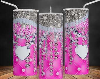 May include: Three pink and silver glitter tumblers with a design of a heart, chains, and diamonds. The tumblers are on a wooden surface.
