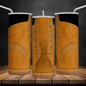 May include: Three stainless steel tumblers with a brown leather boot design. The tumblers have a black top and a brown bottom. The boot design features a brown leather upper with gold eyelets and laces.
