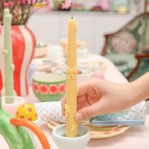 Explore creative placement as candles find their spot on egg-shaped candle holders, creating a visually appealing arrangement.
