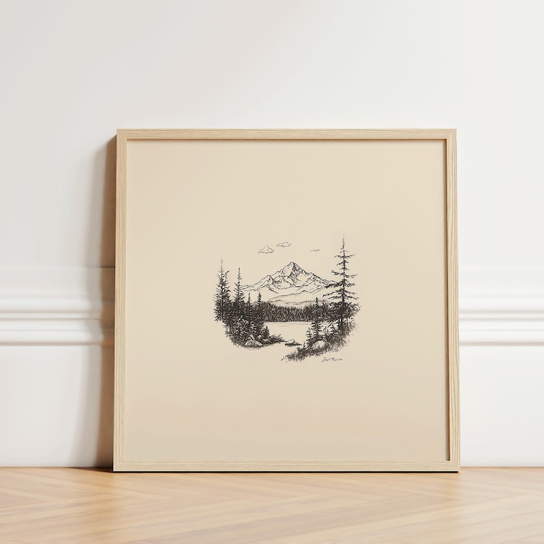 May include: A black and white line drawing of a mountain range with a lake in the foreground. The drawing is framed in a light wood frame.