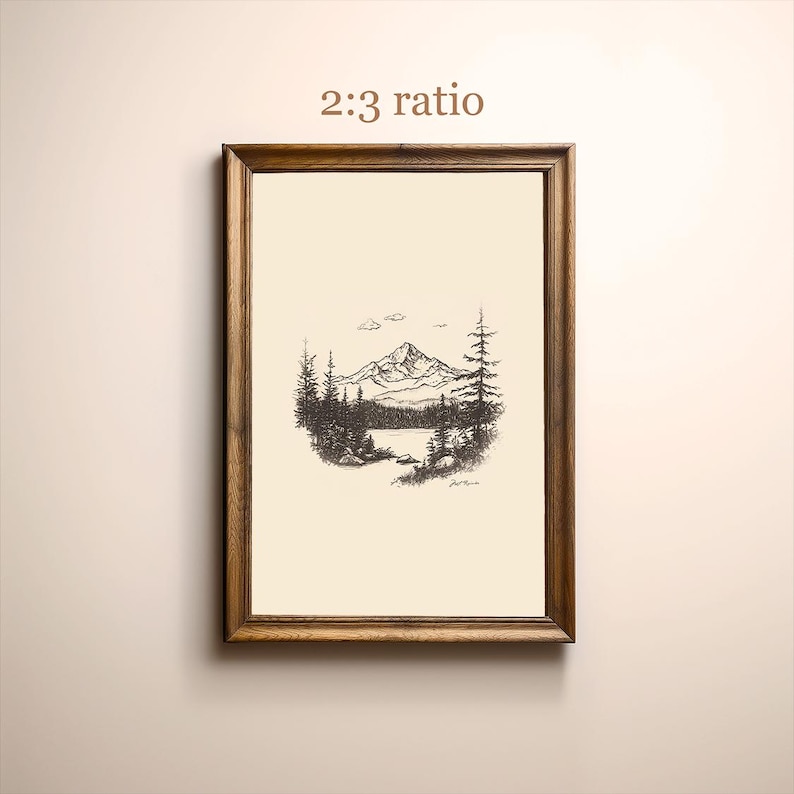 May include: A framed black and white ink drawing of a mountain range with a lake in the foreground. The drawing is in a wooden frame with a white mat. The text "2:3 ratio" is printed above the drawing.