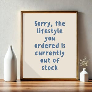 May include: A framed print with a light beige background and blue text that reads "Sorry, the lifestyle you ordered is currently out of stock."