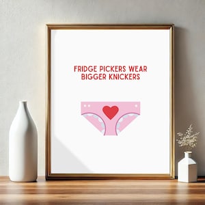 May include: Framed print with the text "FRIDGE PICKERS WEAR BIGGER KNICKERS" above a pink cartoon underwear design with a red heart in the center. The print is in a gold frame.