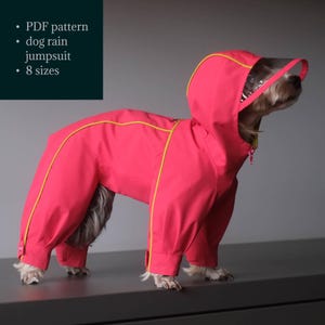 May include: A bright pink dog rain jumpsuit with yellow trim and a clear visor. The jumpsuit covers the dog's entire body, including the legs and head. The text on the image says "PDF pattern, dog rain jumpsuit, 8 sizes."