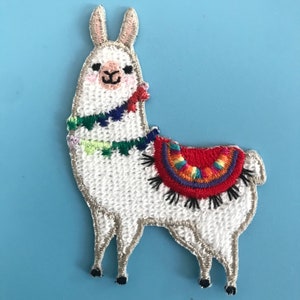 May include: White embroidered llama patch with a red, green, blue, and yellow saddle. The llama has a friendly face and is standing on a light blue background.