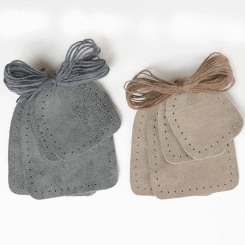 May include: Two sets of leather patches for repairing or decorating leather goods. One set is grey and the other is brown. Each set includes four patches of different sizes and a length of twine.