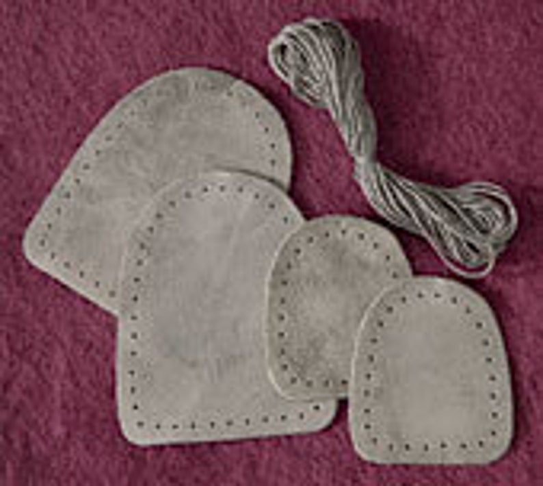 May include: Four grey leather patches with stitched edges, in various sizes, and a spool of grey thread.