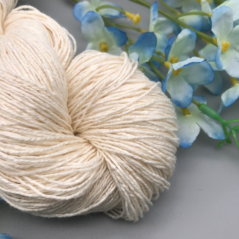 May include: A skein of natural white cotton yarn, perfect for knitting or crocheting projects.