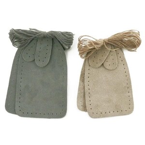 May include: Two sets of leather shoe repair patches, one in grey and one in beige. Each set includes three patches and a length of twine.