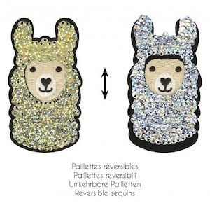 May include: Two llama-shaped reversible sequin patches. One llama is gold and the other is silver. Both have a tan face with black eyes and a heart-shaped nose. The patches are outlined in black.