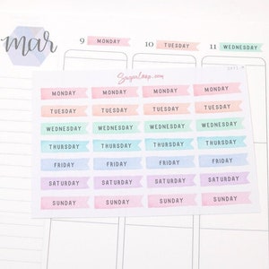 May include: A sheet of colourful planner stickers with the days of the week printed on each sticker. The stickers are in a rainbow colour scheme, with each day of the week having a different colour. The stickers are designed to be used in a planner or journal.