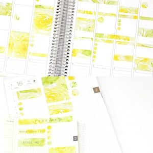May include: A close-up of a planner with a floral design. The planner is open to February and has a to-do list with items such as reading, gym, video edit, vlog, and research.