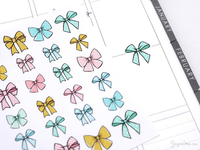 May include: A sheet of colorful bow stickers in various colors, including pink, blue, yellow, and green. The stickers are perfect for adding a touch of whimsy to planners, journals, and other paper crafts.