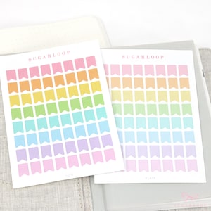 May include: Two sheets of pastel rainbow colored flag stickers with the text "SUGARLOOP" at the top of each sheet.