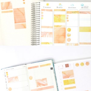 May include: Open planners with watercolor-style stickers and washi tape in shades of orange and yellow. One planner shows the days of the week, while another has a grid layout. The text "ROAD TRIP!" is visible on one page.