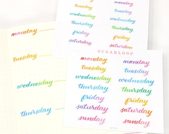 May include: Two sheets of paper with the days of the week written in rainbow colors. The words are written in a handwritten style. The text "SUGARLOOP" appears at the top of each sheet.