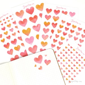 May include: Four sheets of watercolor heart stickers in various sizes. The stickers are pink, orange, and yellow. The stickers are arranged in a fan shape on a white background. The text "Sugarloop.com" is printed on each sheet.