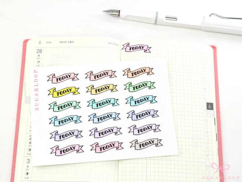 May include: A sheet of colorful 'TODAY' banner stickers. The stickers are in a variety of pastel colors, including pink, blue, green, and yellow. Each sticker features a black banner with the word 'TODAY' printed in black.