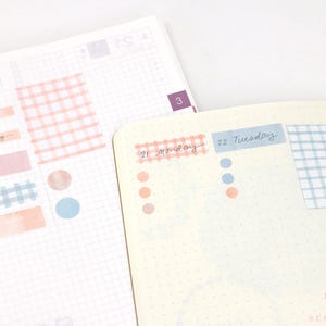 May include: A planner page with a light blue and white gingham pattern, a pink and white gingham pattern, and a pink and white watercolour wash. The page is labelled "21 Monday" and "22 Tuesday".