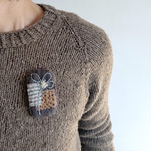 Floral brooch with linen scraps and slow stitched wool