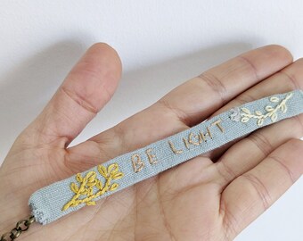 Nature inspired bracelet with embroidered words - Be Light - and florals - aqua blue linen