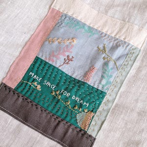 Light grey linen tote bag with hand embroidered patchwork collage