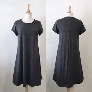 May include: A simple, dark gray, short-sleeved, A-line dress with a round neckline.