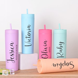 May include: A collection of personalized tumblers in various pastel colors, each with a name in elegant script. The tumblers include Jessica, Victoria, Olivia, Ruby, and Sophia. Each tumbler has a matching straw.