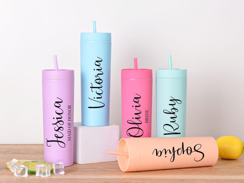 May include: A collection of personalized tumblers in various pastel colors, each with a name in elegant script. The tumblers include Jessica, Victoria, Olivia, Ruby, and Sophia. Each tumbler has a matching straw.