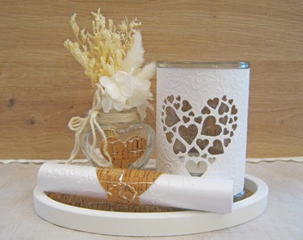 Decorative ceramic tray with candle glass, scroll and glass vase with bouquet