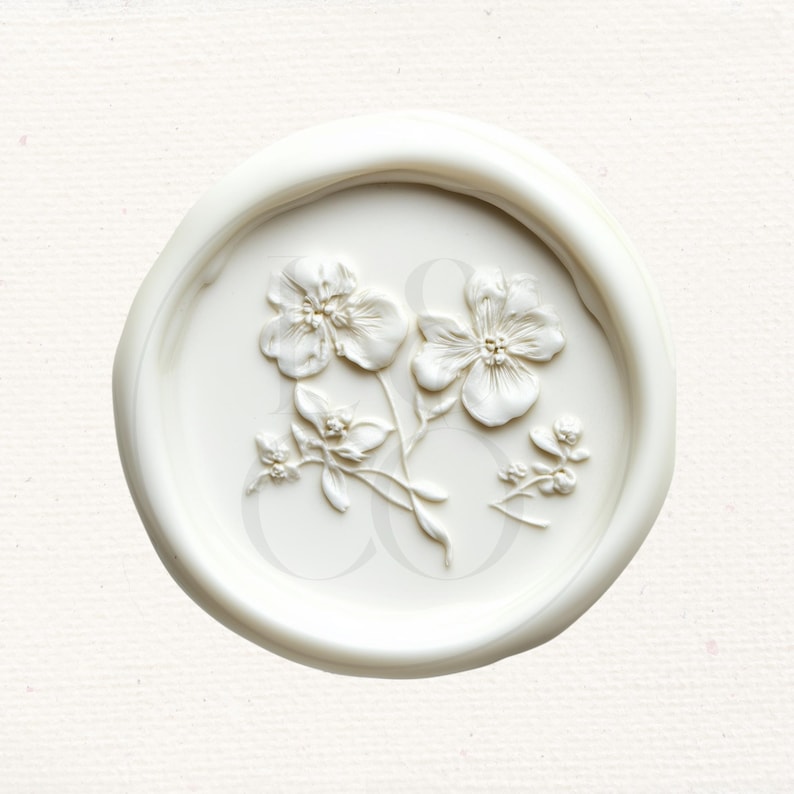 May include: White wax seal with a raised design of three white flowers and leaves.