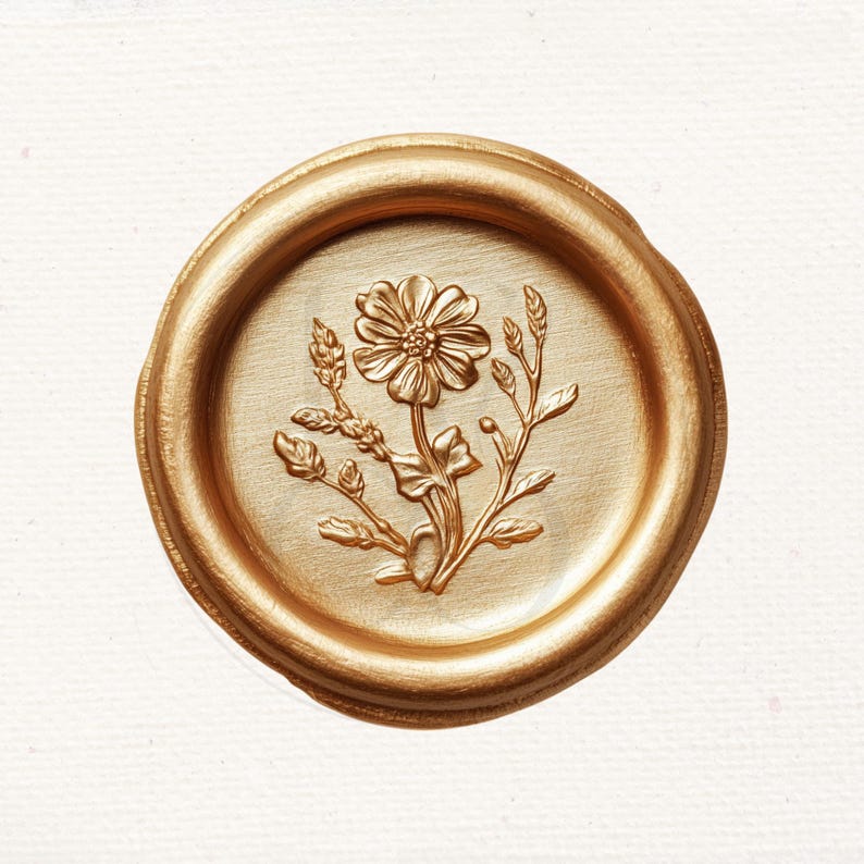 May include: A gold wax seal with a detailed floral design featuring a flower and leaves.