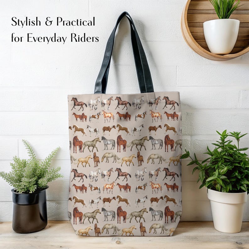 Neutral-toned horse tote bag hanging on a whitewashed wall, surrounded by greenery. Designed for practical daily use, this spacious bag carries gear from barn to market with ease. A fashionable, sturdy solution for horse lovers, moms, and riders who want both style and strength. Reinforced straps, durable fabric, and versatile use.