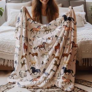 "Smiling woman with velveteen horse blanket – cozy farmhouse equestrian throw, rustic western style decor and horse lover gift blanket."