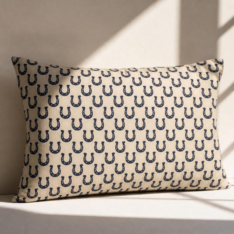 Preppy navy horseshoe lumbar pillow in sunlight, beige equestrian throw pillow, minimalist farmhouse decor accent