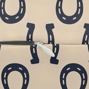 Horseshoe pillow cover fabric detail with concealed zipper, durable spun polyester lumbar pillow texture close-up