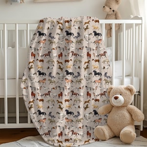 "Horse blanket draped over crib – soft velveteen equestrian throw for nursery, cozy baby shower gift for horse lovers."