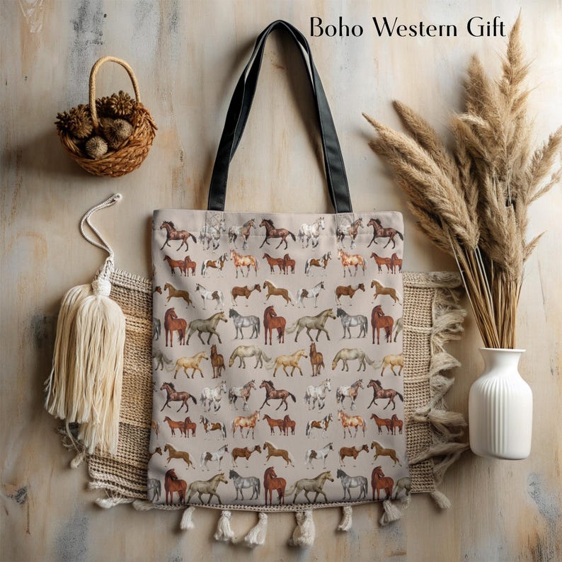 Alt Text:
Boho-style horse tote bag laid flat with rustic textures and cozy farmhouse elements. Hand-illustrated horse design makes it an ideal Western-themed gift for horse moms, barn babes, or rodeo fans. Sturdy, spacious, and aesthetic—this tote blends function with flair, making it a great choice for stylish equestrians and nature lovers.