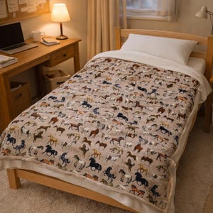 Beige horse plush blanket on bed in warm cozy bedroom, velveteen throw with horse breeds print, western decor bedding, horse lover room styling, farmhouse neutral blanket, rustic country bedroom decor, equestrian home accessory, soft plush comfort blanket, aesthetic horse pattern throw, winter cozy bedding, gift for horse girls, western home decor, country style bedroom, horse themed bedding