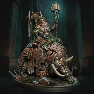 Può includere: Una miniatura di un guerriero barbuto in armatura di bronzo che cavalca un grande orso corazzato. Il guerriero tiene un bastone sormontato da un libro e uno stendardo verde. L'orso indossa piastre metalliche con intricati motivi a intreccio.