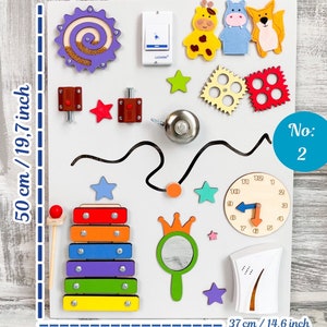 May include: A white wooden busy board with various interactive elements. Includes a xylophone, clock, gears, bell, and felt animal shapes. The board measures 19.7 inches tall and 14.6 inches wide.