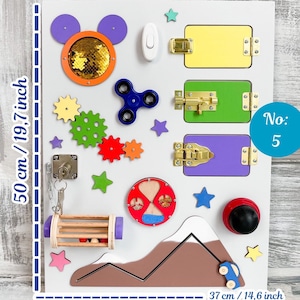 May include: A white wooden activity board, 19.7 inches tall and 14.6 inches wide, with various colorful interactive elements. Features include latches, gears, a spinner, and a Mickey Mouse-shaped element with sequins. Includes a small car and mountain design.