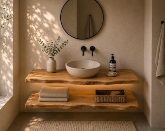 May include: A bathroom vanity featuring two natural live-edge wooden shelves with integrated under-shelf lighting. A round beige vessel sink sits on the top shelf next to a ceramic vase with greenery, a soap dispenser, and a small soap dish.