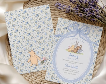 May include: Two rectangular paper cards featuring a blue floral pattern. One card shows Winnie the Pooh and Piglet. The other card features a blue bow, an oval frame, and text reading A SWEET LITTLE hunny IS ON THE WAY! Please join us for a baby shower in honor of Elise Smith.