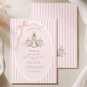May include: Pink and white striped baby shower invitation with a bunny illustration. The invitation reads "A sweet little bunny is on the way!" and includes event details. A matching envelope is also visible.