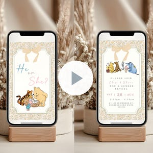 May include: Two smartphones on wooden stands display gender reveal invitations. One says "He or She?" with Winnie the Pooh characters. The other says "Please join Elise & Shane for a gender reveal" with the date, time, and location.