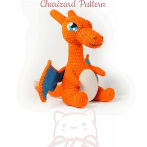 May include: Orange and blue crocheted Charizard plush toy. The toy is sitting with its wings spread out. The toy has a white belly and blue eyes.